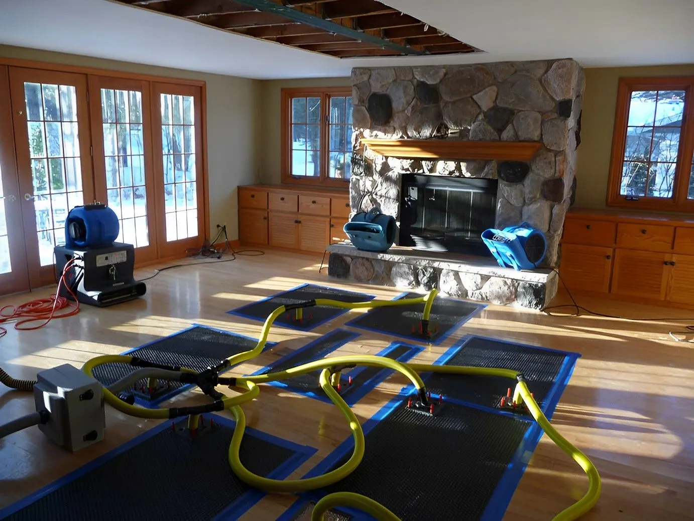 Professional drying equipment working on water-damaged hardwood floors in a Toronto home